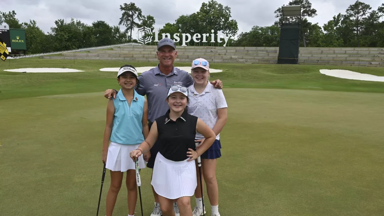 group of golfers posing on the green together